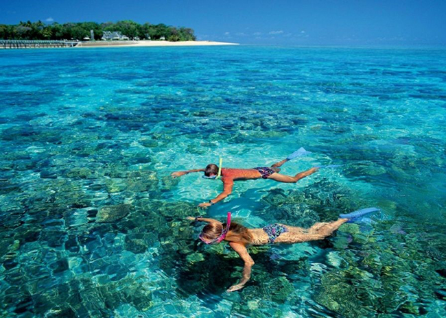 Peter and his girlfriend over the surface admiring the marine life of Cozumel.