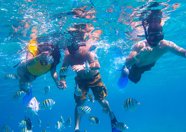 Chrystal and her husband very happy to start a snorkeling tour with her son.